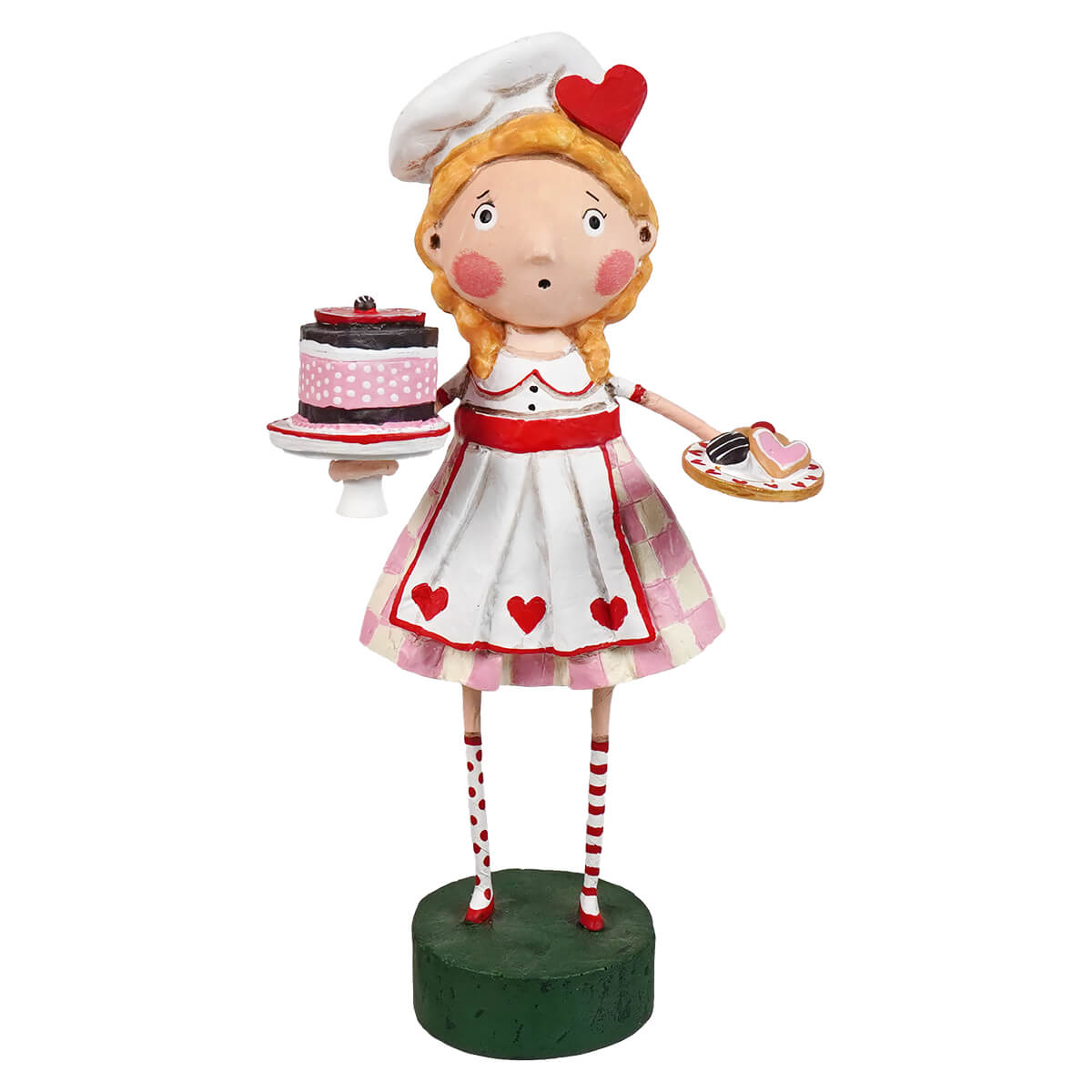 A lori mitchell charming baker figurine in white holding a pink polka dot cake and valentine treats spreading holiday cheer