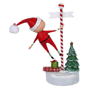 Swinging into christmas features a red and white candy cane pole with a climbing elf and christmas decorations and ornaments