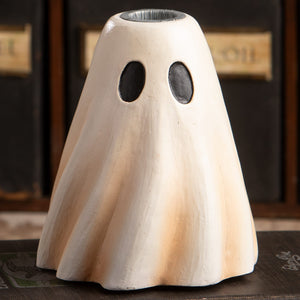 Tall white ceramic ghost candlestick with black eye cutouts and textured surface perfect for halloween ghost figures decor