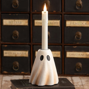 Tall ghost candlestick ceramic white ghost figure candle holder with black eyes holding lit white taper candle for halloween decor