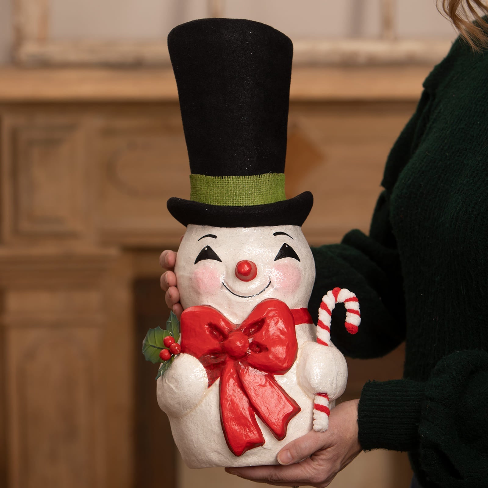 A cheerful white tall hat jolly snowman figurine with black top hat red bow tie and candy cane from bethany lowe designs christmas snowman figures and decor
