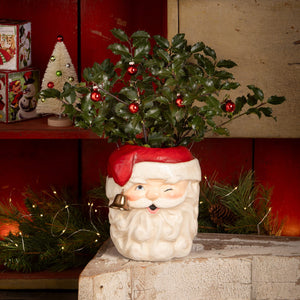 A bethany lowe design tall santa bucket ceramic planter with red hat white beard blue eyes and golden bell cheek