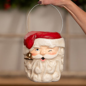 A charming red and white bethany lowe design tall santa bucket with a gold bell hanging from his beard christmas buckets and lanterns