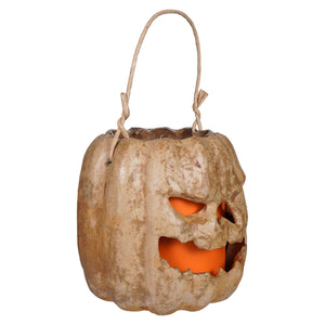 A handcrafted folk art tan scary face pumpkin bucket lantern with glowing orange light and raggedy junction design