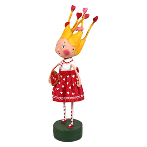 A lori mitchell folk art figurine called tangled in love featuring a girl in a red heart dress spreading holiday cheer
