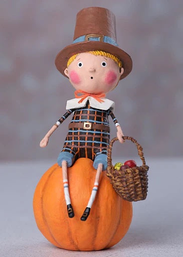 A lori mitchell thankful thad figurine of a pilgrim boy in plaid sitting on a pumpkin with a basket of apples thanksgiving decor