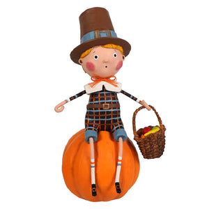 A charming brown pilgrim figurine named thankful thad in plaid outfit holding a basket on a pumpkin for thanksgiving decor by lori mitchell