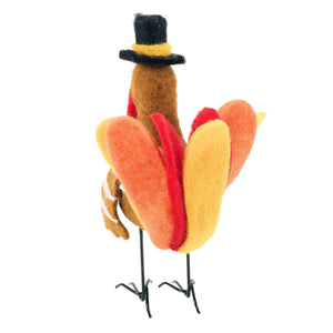 A festive thanksgiving turkey critter felt ornament with vibrant orange red yellow feathers and a black top hat from kathy design harvest collection