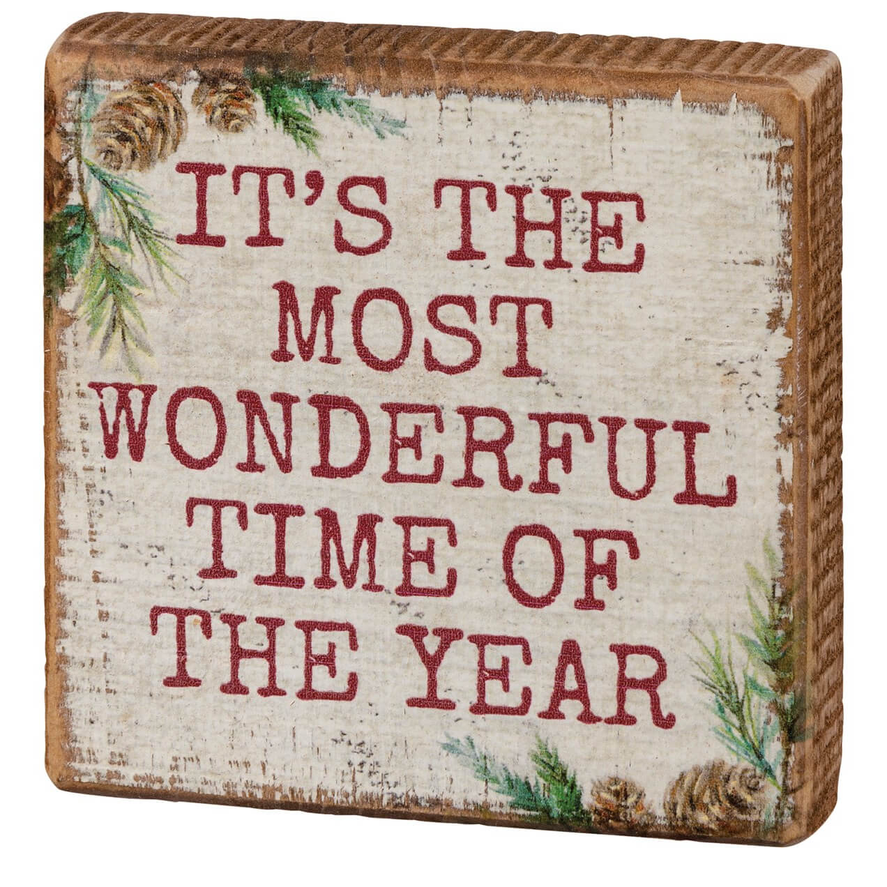 Wooden sign with festive text about the most wonderful time of the year, decorated with pine branches and pinecones.