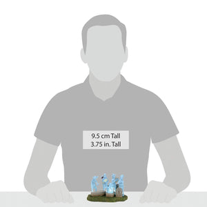 A translucent light blue phantom five figurine set by department 56 showing a miniature band on a grassy base
