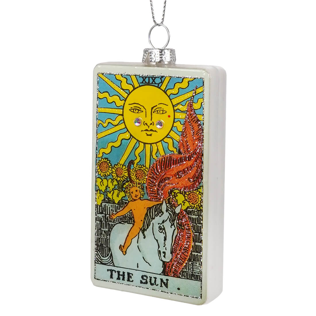 A rectangular glass christmas ornament featuring the sun tarot card with yellow sun and white horse by cody foster