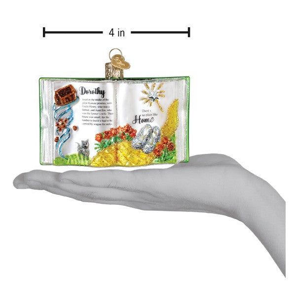 A green and white glass figural decor ornament from the wonderful wizard of oz with a gold heart tag for world christmas trees