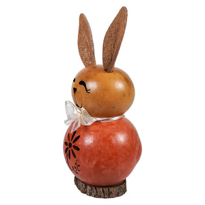 A charming wooden orange willow bunny gourd with amber head black floral etchings and white ribbon bow perfect for easter bunny decor