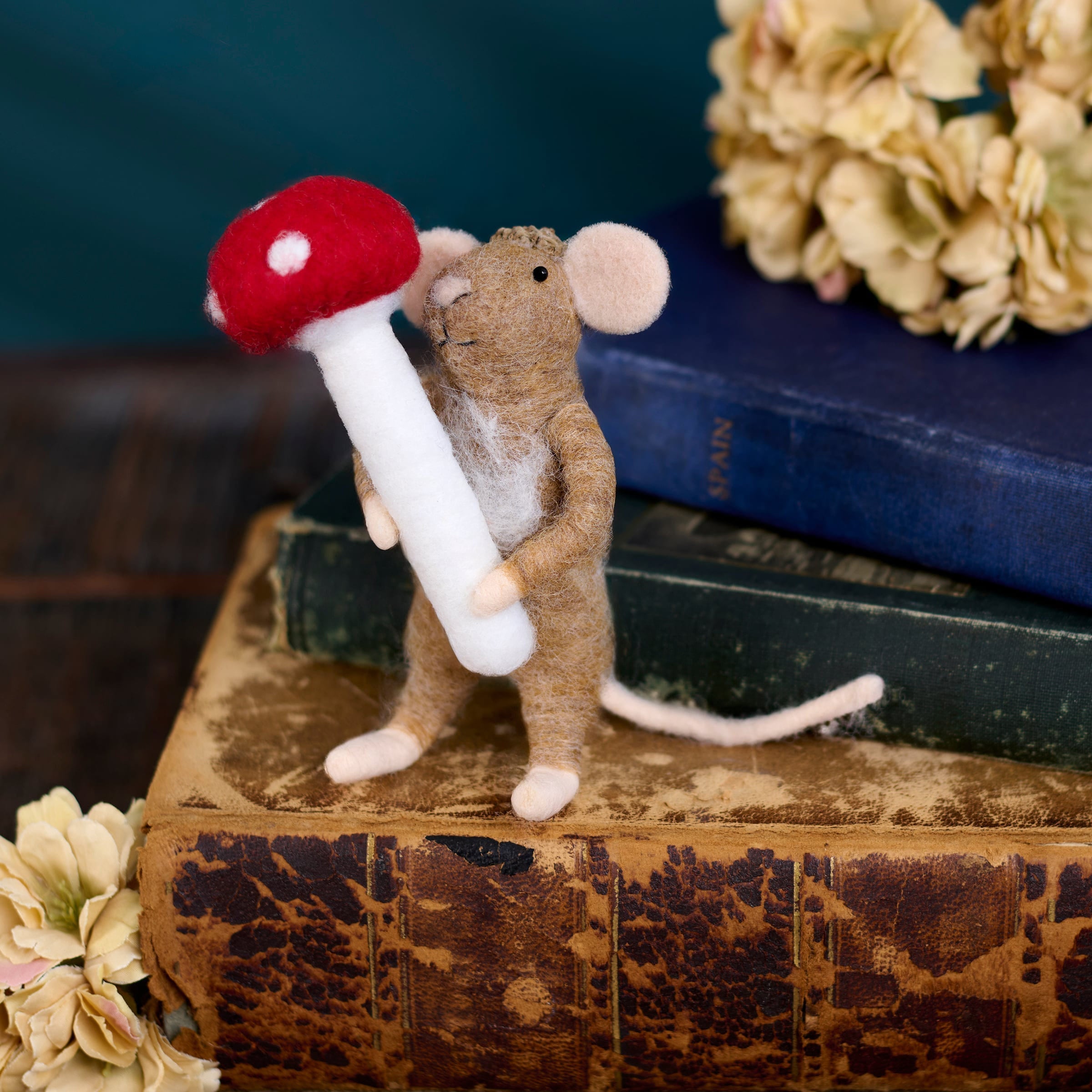 A charming brown felt switch mouse critter holding a red-capped toadstool mouse critter ornament perfect for witch switch decor