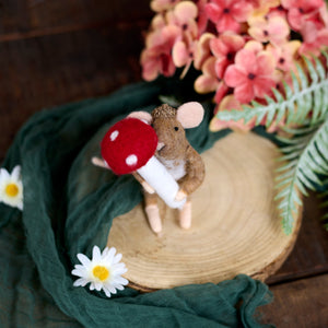 A charming brown felt mouse critter ornament holding a red and white mushroom witch switch design