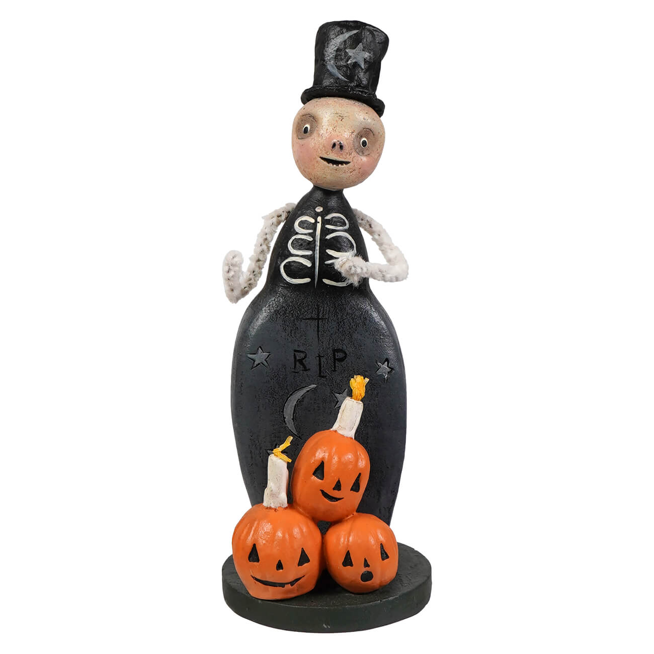 A whimsical black skeleton trickster figurine with a top hat stands beside three orange jack o lanterns halloween figural decor