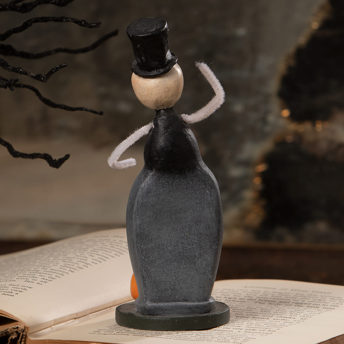 Handcrafted halloween figural decor tombstone trickster with black top hat beige head and white pipe cleaner arms on dark base