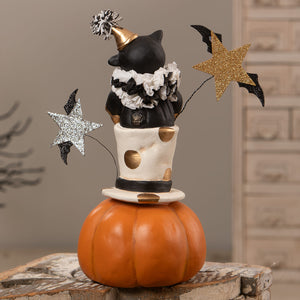 Top hat jack with cat featuring a black cat figurine in a gold party hat on a polka dot top hat over an orange jack o lantern