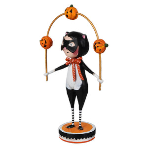 Black and white cat figurine wearing a mask and bow tie balancing jack o lanterns on poles for lori mitchell halloween
