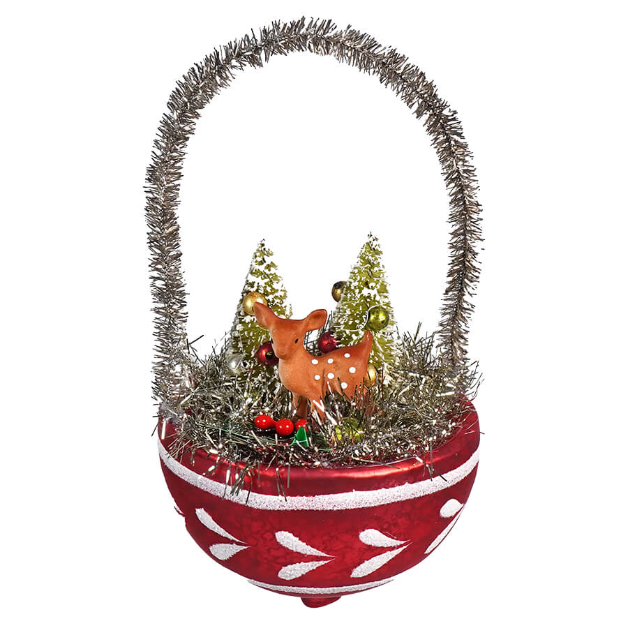 Christmas ornament basket featuring a deer figurine, miniature trees, and tinsel decorations.