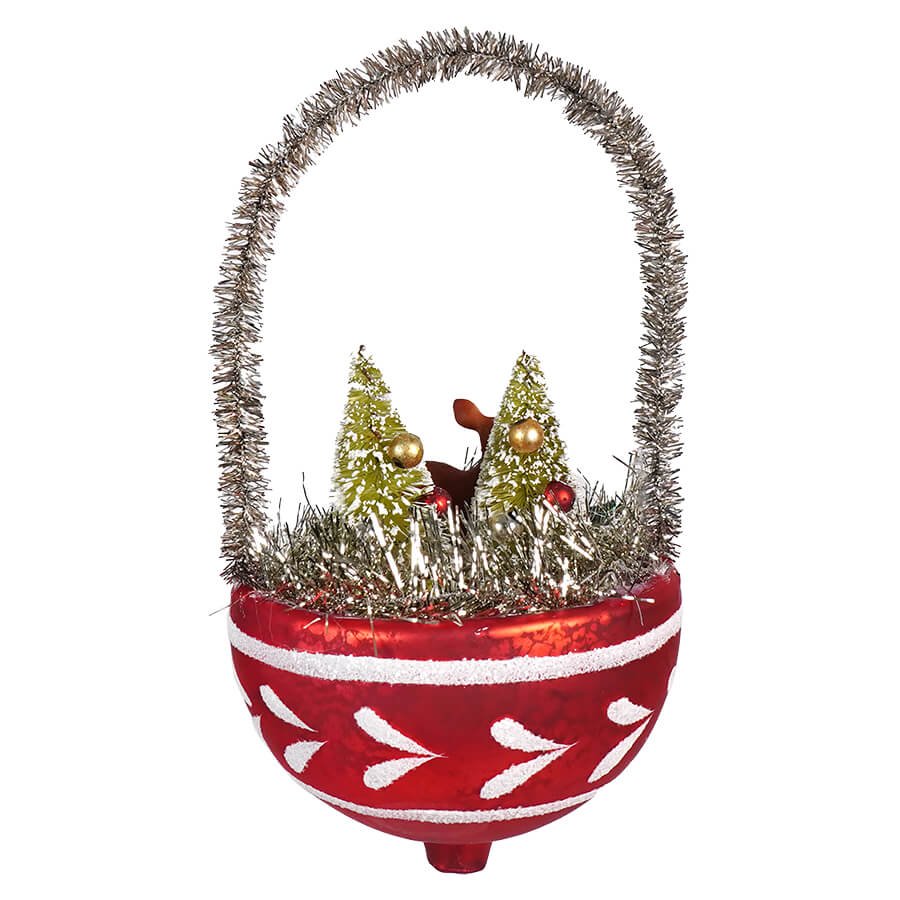 Christmas ornament shaped like a basket with miniature trees inside and a tinsel handle.