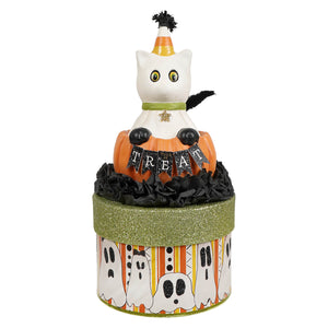 A white ceramic casper cat figurine with candy corn hat on an orange pumpkin in a halloween cats themed box