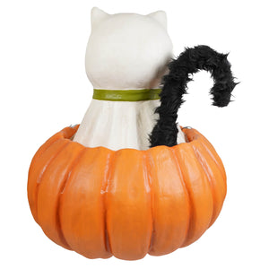 White cat figurine with black fuzzy tail and green collar seated inside orange pumpkin planter for trick or treat casper halloween cats