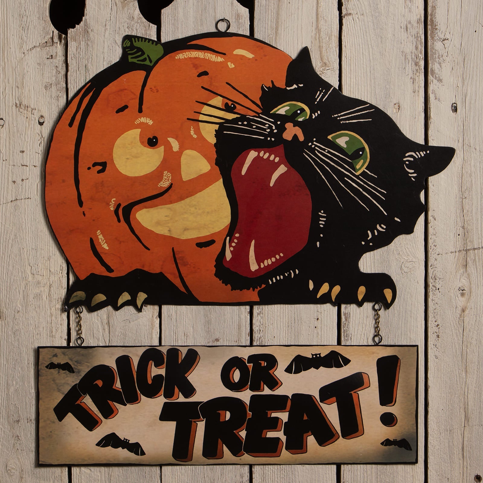 Orange and black wooden trick or treat sign with carved pumpkin and black cat halloween hanging and wall decor