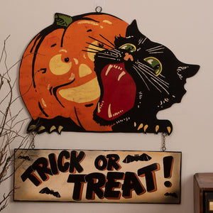 Vintage trick or treat sign featuring a black cat biting an orange pumpkin halloween hanging wall decor