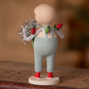 A whimsical bethany lowe designs santa figure of a child in blue overalls holding festive tinsel and string lights