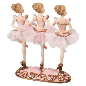 Pink resin triple ballerina table piece with three ballerinas in matching tutus on an ornate pink and gold base