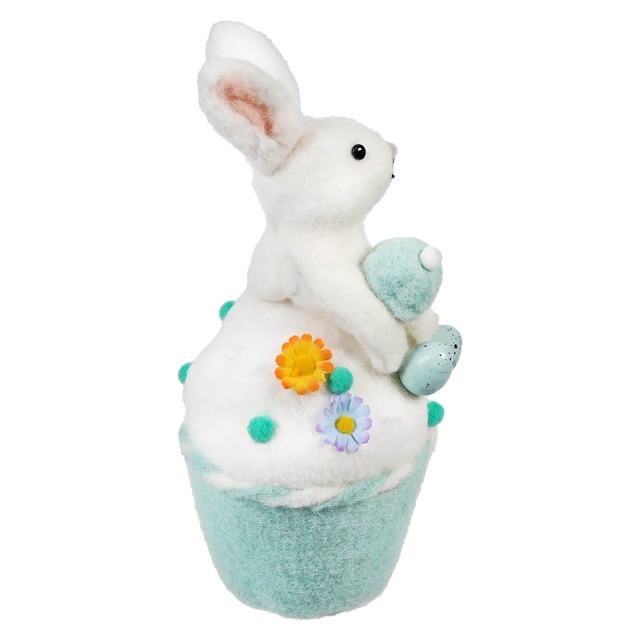 White plush bunny sitting atop a mint-colored cupcake base decorated with flowers and pom-poms.