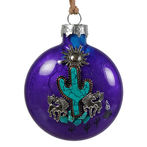 Vibrant purple glass ornament featuring a turquoise cactus with silver spirited horses and sun embellishments