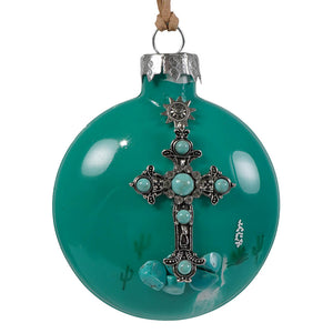 Teal glass ornament featuring a turquoise cross glass design with silver details and crystals hanging by twine loop