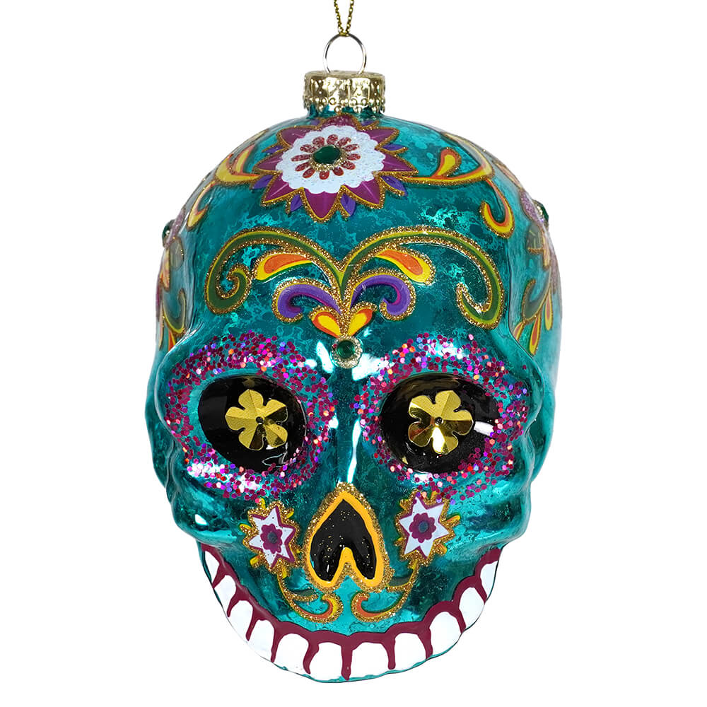 Turquoise day of the dead glass skull ornament with glittery purple gold floral patterns perfect for halloween ornaments