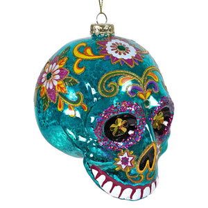 Teal glass day of the dead sugar skull ornament with glittery floral designs perfect for halloween ornaments