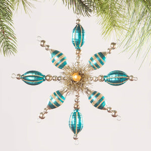 Ornate turquoise and gold snowflake-shaped Christmas ornament with beaded arms.