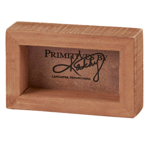 Terracotta-colored rectangular box with ’Primitives by’ branding from Lancaster, Pennsylvania.
