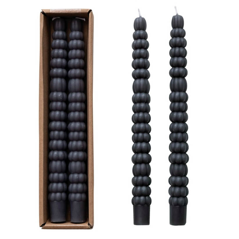 Black, ribbed candles with a long, slender shape.