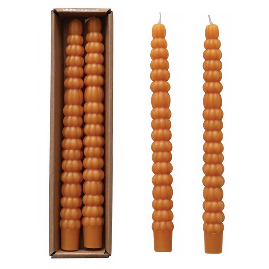 Pair of tall, orange, beaded beeswax candles with a matching box.