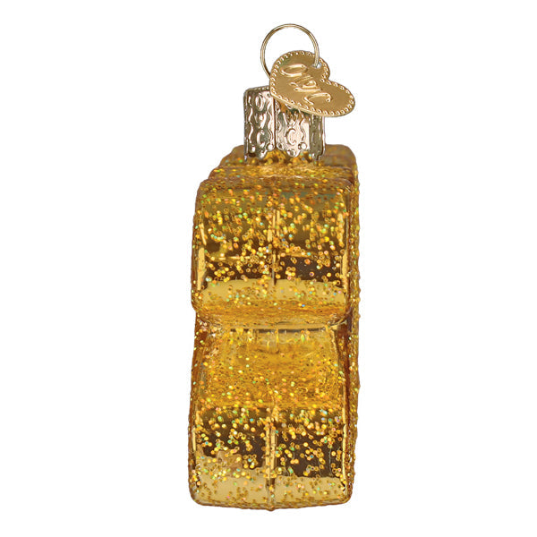 Golden glitter ornament shaped like stacked gift box with silver cap and heart tag for usa 2026 world christmas special year