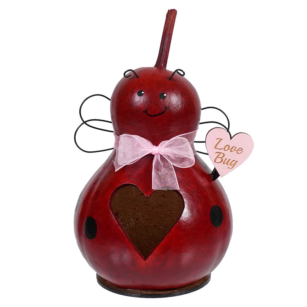 Red ladybug ornament with a pink bow and heart decorations.