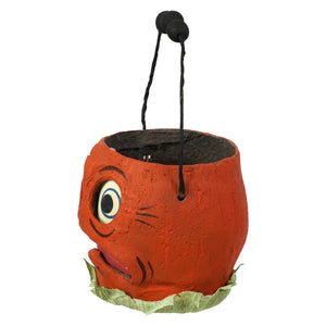 Orange pumpkin shaped halloween bucket with painted face black handle and green leafy base by vandolls folk art rachel garrison