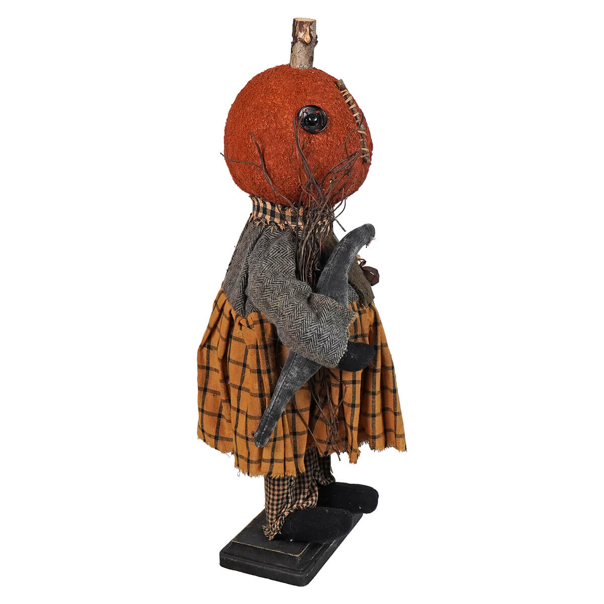 Creepy Halloween-themed doll with a pumpkin head wearing a plaid skirt and holding a black cat.