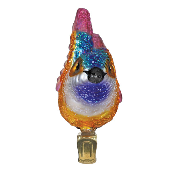 Vibrant hummingbird ornament made of iridescent glass with glittery blue purple chest and orange wings for figural decor