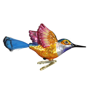 Vibrant hummingbird ornament with iridescent pink and gold wings blue tail feathers metallic finish figural decor