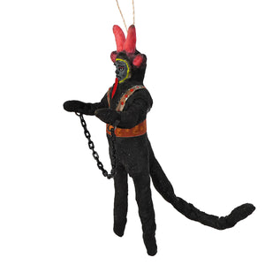 Vintage handcrafted cotton krampus ornament featuring a black devil figurine with red horns and chain made from painted clay