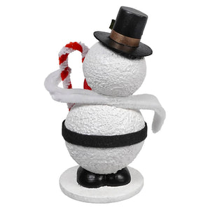 Decorative snowman figure wearing a black top hat and holding a candy cane.