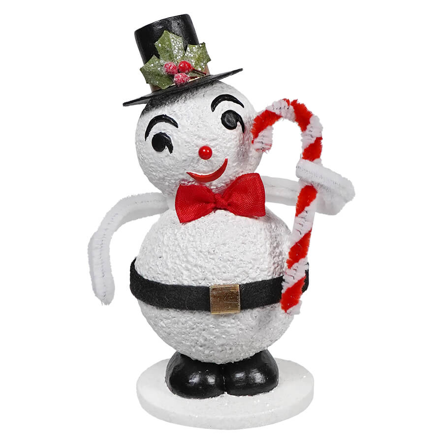 A cheerful snowman decoration wearing a top hat, red bow tie, and holding a candy cane.