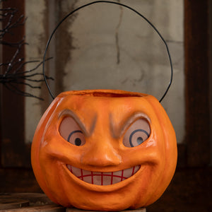 Vintage mad pumpkin bucket orange halloween bucket with black wire handle and cartoonish face for halloween pumpkins and gourds